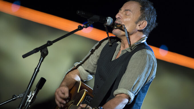 Bruce Springsteen plays harmonica and guitar during his set for The Concert for Valor in Washington, D.C. Nov. 11, 2014. DoD News